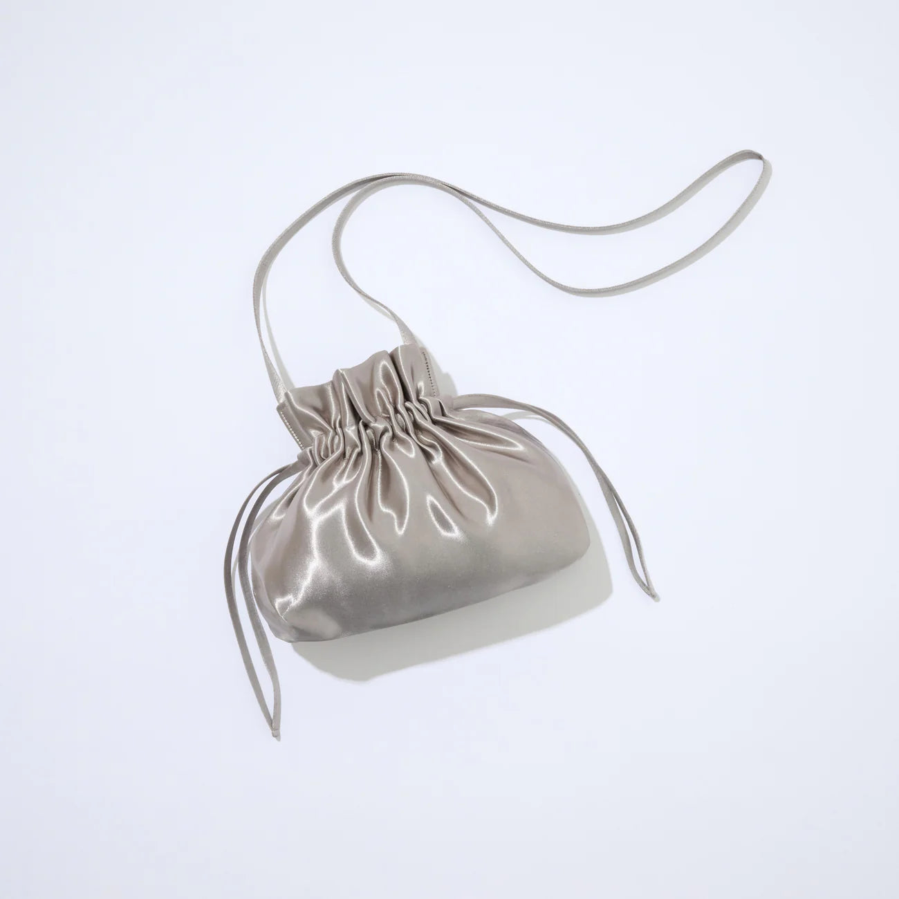 Silver drawstring bag on a light gray background
