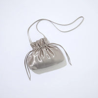 Silver drawstring bag on a light gray background