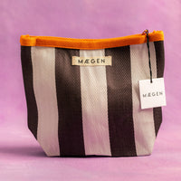 Striped pouch with orange zipper and 'Megen' branding on a purple background