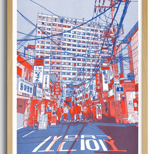 Framed artwork of a cityscape with red and blue tones on a white background