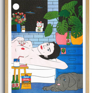 Framed artwork of a woman lying on a bed with a cat, in a room with plants and a window.