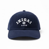 Navy blue cap with 'IKIGAI' text on a wooden surface