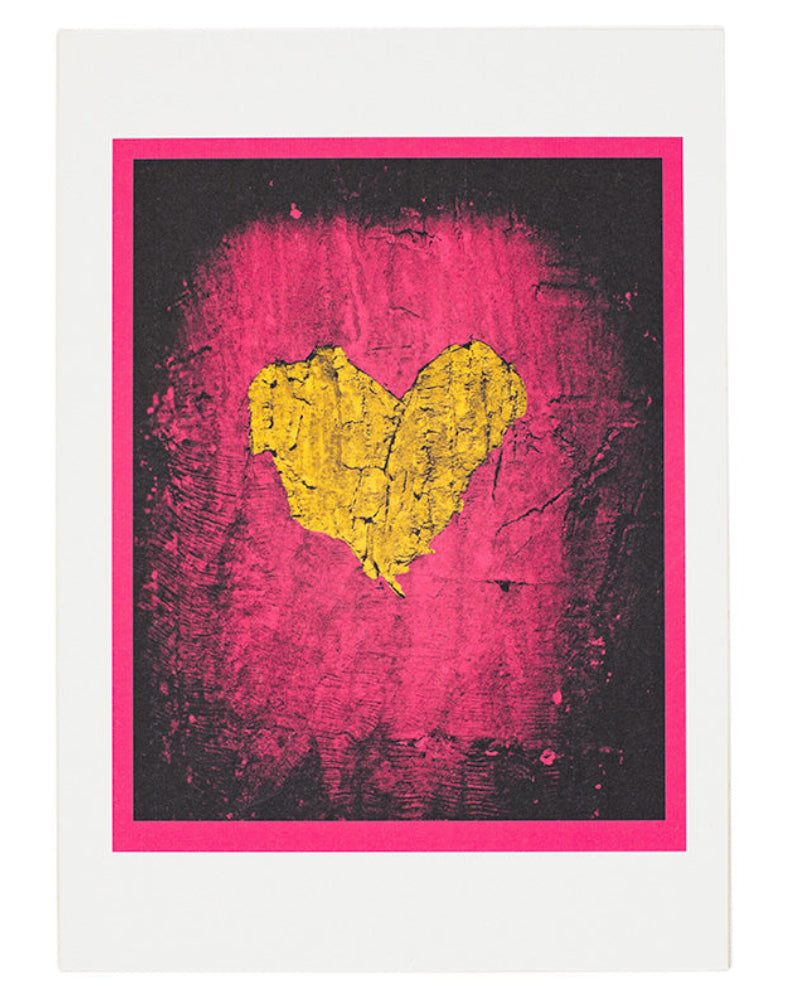 Framed artwork with a yellow heart on a pink and black background