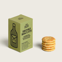 Green box of 'Drinks Biscuits' with a stack of biscuits on a light background