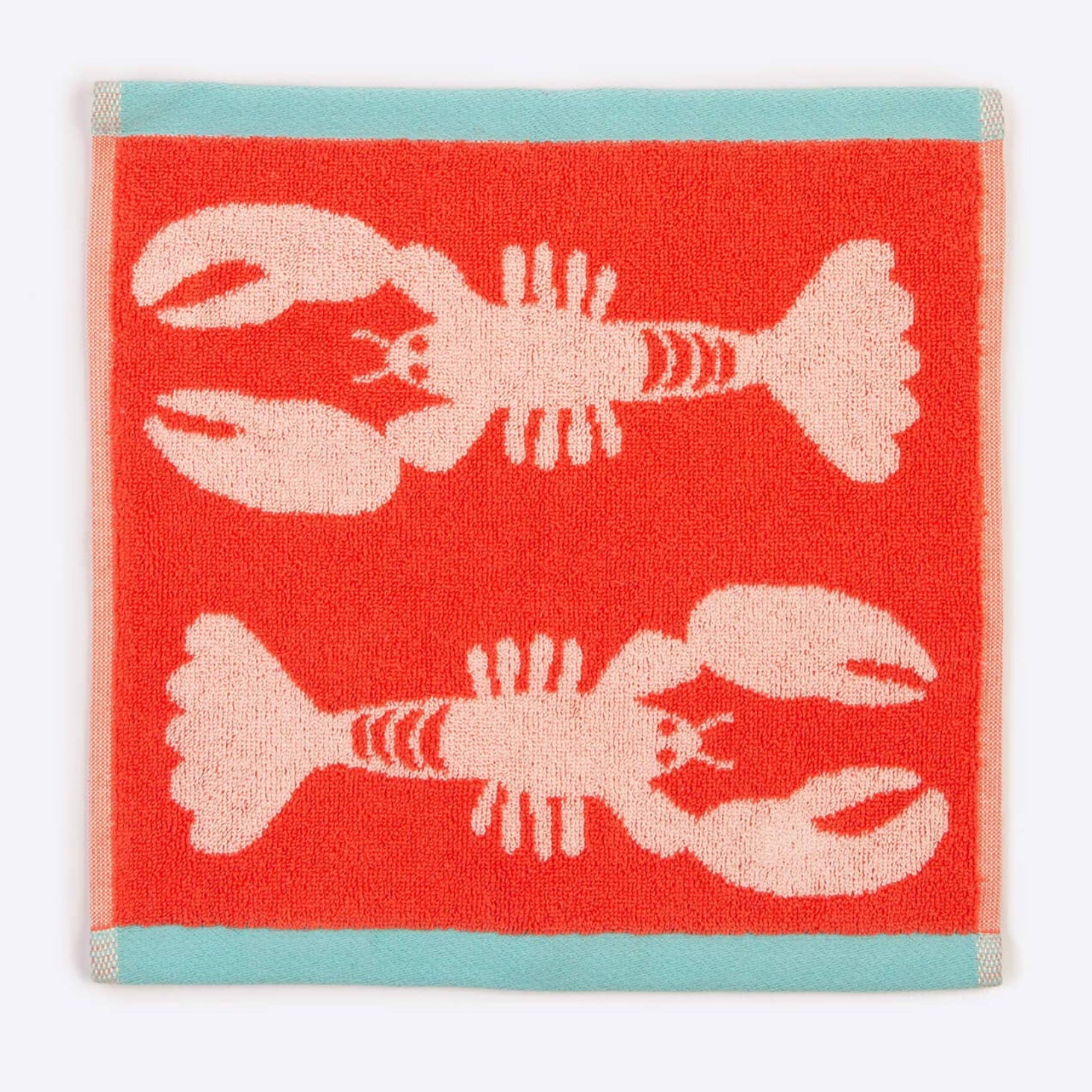 Red towel with pink lobster design on a white background